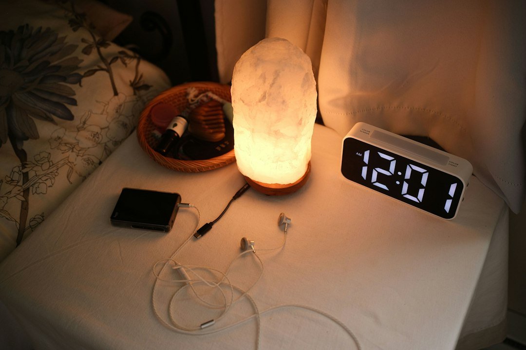 Bedside clock and lamp illustrating a consistent healthy sleep routine